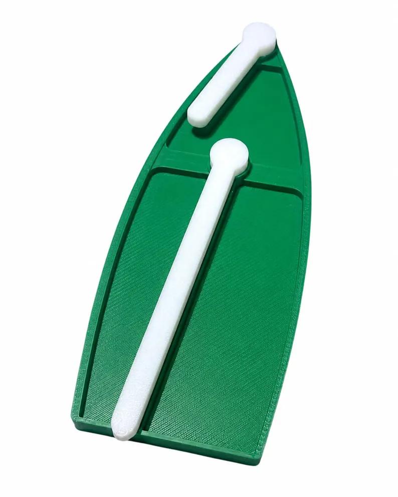 Close-up of a single green 3D-printed boat token